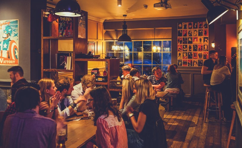 People sat around tables drinking at The Cork in Bath